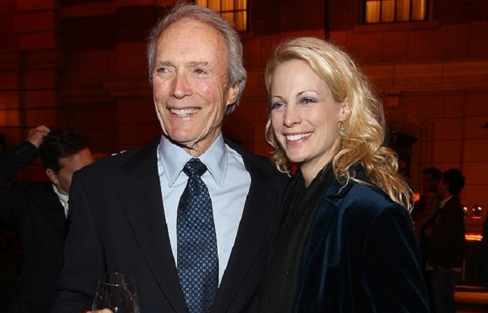 Jacelyn Reeves and Clint Eastwood poses for a picture.